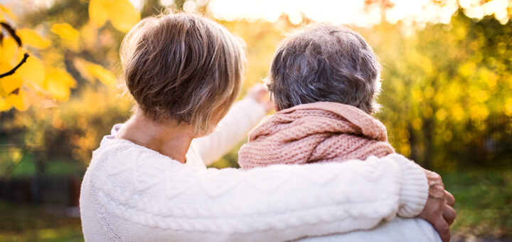 Woman and Mother with dementia looking at leaves